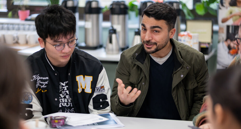 Two students sat at a table talking