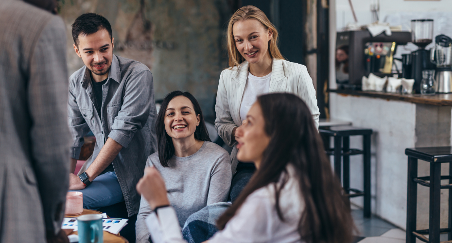 Group of four students talking together