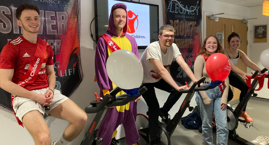 RAD society members on exericise bikes, dressed in fancy dress.