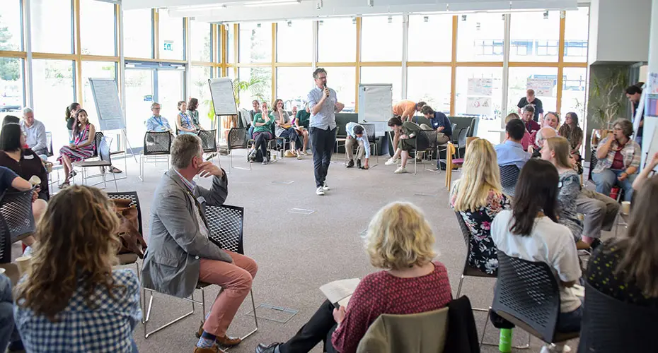 Meeting with a speaker addressing large room