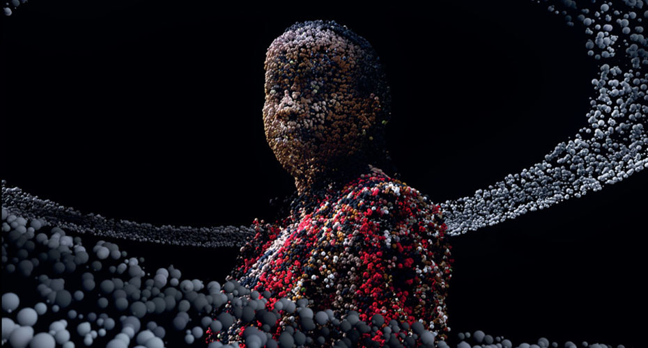 A digital artwork depicting a human figure composed of numerous small, colorful spheres. The figure stands against a dark background with a swirling pattern of spheres around them, creating a sense of movement. The spheres vary in color, predominantly featuring shades of red, black, and gray, giving the figure a textured, almost pixelated appearance.