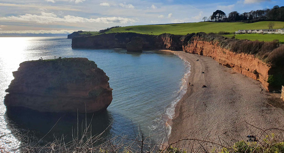 Beach with blue sky and sea stack