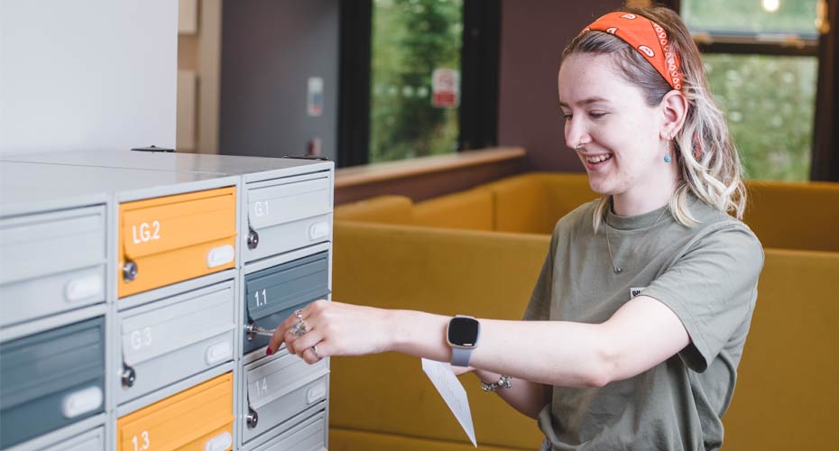 Student collecting her post from a locker