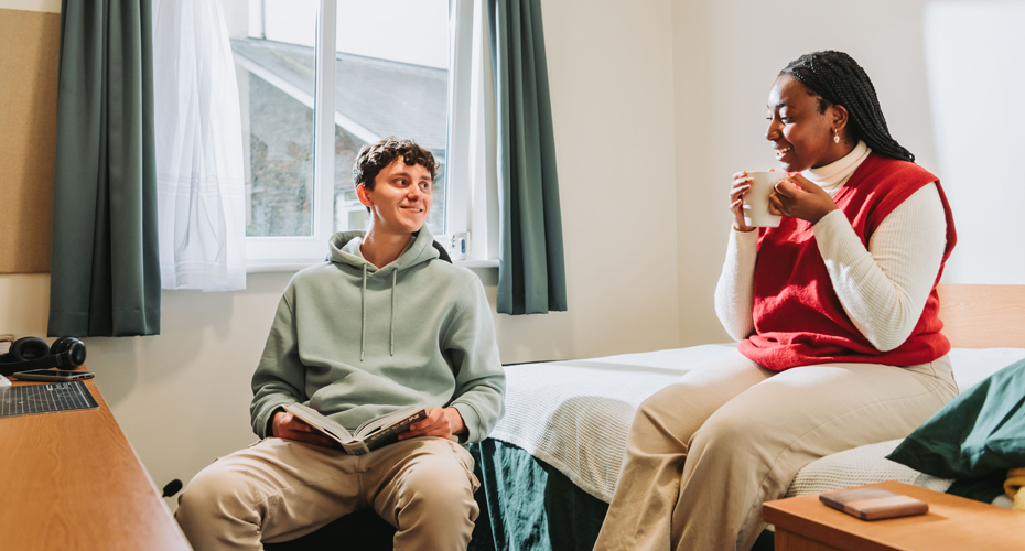 two students sat in bedroom